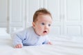 Smiling baby tummy time in a white nursery Royalty Free Stock Photo