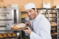 Smiling baker smelling fresh bread