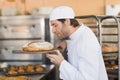 Smiling baker smelling fresh bread