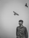 Smiling Bangladeshis man looking at something under two flying birds - freedom concept Royalty Free Stock Photo