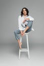 Smiling barefoot woman sitting on chair