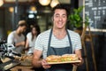 Smiling barista holding sandwiches Royalty Free Stock Photo