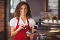 A smiling barista pressing coffee