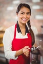 Smiling barista steaming milk at the coffee machine Royalty Free Stock Photo