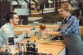 Smiling barista taking payment from client Royalty Free Stock Photo