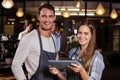 Smiling baristas using tablet Royalty Free Stock Photo