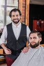 smiling bearded barber with client Royalty Free Stock Photo