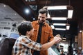 Smiling bearded barber holding hand of Royalty Free Stock Photo