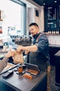 Smiling bearded Caucasian man cashier barista in restaurant cafe at work. Royalty Free Stock Photo