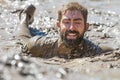 Smiling bearded face covered in mud