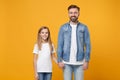 Smiling bearded man in casual clothes have fun with child baby girl. Father little kid daughter isolated on yellow Royalty Free Stock Photo