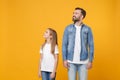 Smiling bearded man in casual clothes have fun with child baby girl. Father little kid daughter isolated on yellow Royalty Free Stock Photo