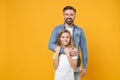 Smiling bearded man in casual clothes have fun with cute child baby girl. Father little kid daughter isolated on yellow Royalty Free Stock Photo