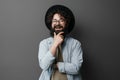 Smiling bearded man in hat posing against grey background Royalty Free Stock Photo