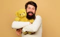 Smiling Bearded Man Hugging Teddy Bear. Birthday Celebration. Happy Guy Embrace Soft Plush Toy.
