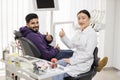 Smiling bearded man sitting in the dentist's chair in light modern dental clinic Royalty Free Stock Photo