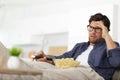 smiling bearded man sitting on sofa