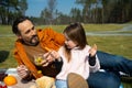 Cute little girl having picnic with father