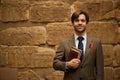 Smiling bearded schoolteacher in museum carrying books