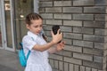 Smiling beatiful preteen girl taking a selfie outdoors. Child taking a self portrait with mobile phone. technology Royalty Free Stock Photo