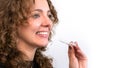 Smiling beautiful adult woman holds invisalign transparent braces in her hand