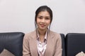 Smiling beautiful asian female professional manager sitting looking at camera, happy confident business woman corporate leader