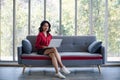 Asian woman using notebook computer on sofa Royalty Free Stock Photo