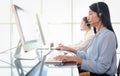 Smiling beautiful Asian woman with headphones work at call center service desk consultant, call center agent with headset talk Royalty Free Stock Photo