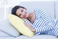 Smiling beautiful brunette relaxing on the couch and looking at camera Royalty Free Stock Photo