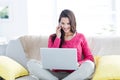 Smiling beautiful brunette speaking on the phone while using laptop Royalty Free Stock Photo