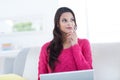 Smiling beautiful brunette using her laptop on the couch Royalty Free Stock Photo