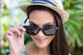 Smiling beautiful brunette wearing straw hat and sun glasses Royalty Free Stock Photo