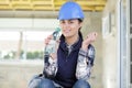 smiling beautiful builder woman holding bottle water