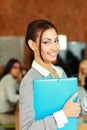 Smiling beautiful businesswoman standing with folder Royalty Free Stock Photo