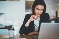 Smiling beautiful businesswoman using laptop computer at modern office.Blurred background.Horizontal. Royalty Free Stock Photo