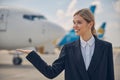 Pleased airport employee looking into the distance Royalty Free Stock Photo