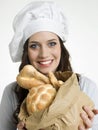 Smiling Female Chef Holding Bag of Breads
