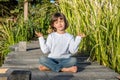 Smiling beautiful child doing yoga bare feet for relaxing energy Royalty Free Stock Photo