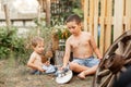 Smiling beautiful family on the backyard lawn. Childs expression Royalty Free Stock Photo