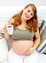 Smiling beautiful female holding cup of tea