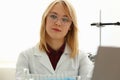 Pretty young woman sitting in the laboratory Royalty Free Stock Photo