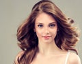 Smiling Beautiful girl, brown hair with an elegant hairstyle , hair waves , curly. Royalty Free Stock Photo