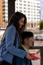 Smiling beautiful girl covering her boyfriend`s eyes and giving him a surprise gift for the celebration of a special day, vertica Royalty Free Stock Photo