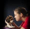 Smiling beautiful girl getting puppy in purple gift box for Christmas or Birthday