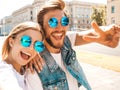 Handsome man and his beautiful girlfriend posing outdoors Royalty Free Stock Photo