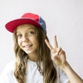 Smiling beautiful girl teenager in a baseball cap and white t-shirt Royalty Free Stock Photo