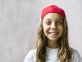 Smiling beautiful girl teenager in a baseball cap and white t-shirt Royalty Free Stock Photo