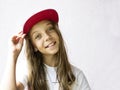 Smiling beautiful girl teenager in a baseball cap and white t-shirt Royalty Free Stock Photo