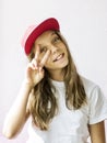 Smiling beautiful girl teenager in a baseball cap and white t-shirt Royalty Free Stock Photo