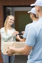 Girl and two couriers in blue uniforms Royalty Free Stock Photo